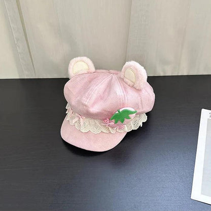 Pink bear cap with lace trim and strawberry applique, side view