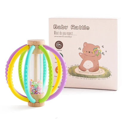 Baby rattle teether toy with purple, yellow, and green silicone rings and wood handle