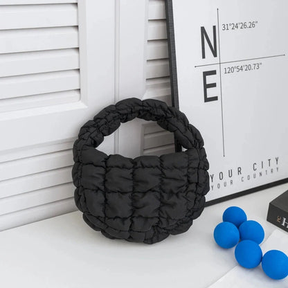 Quilted puffer circle mini bag with top handle, black padded nylon.