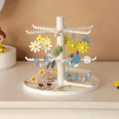 White rotating earring display stand with three-tier hook layout and hanging charms