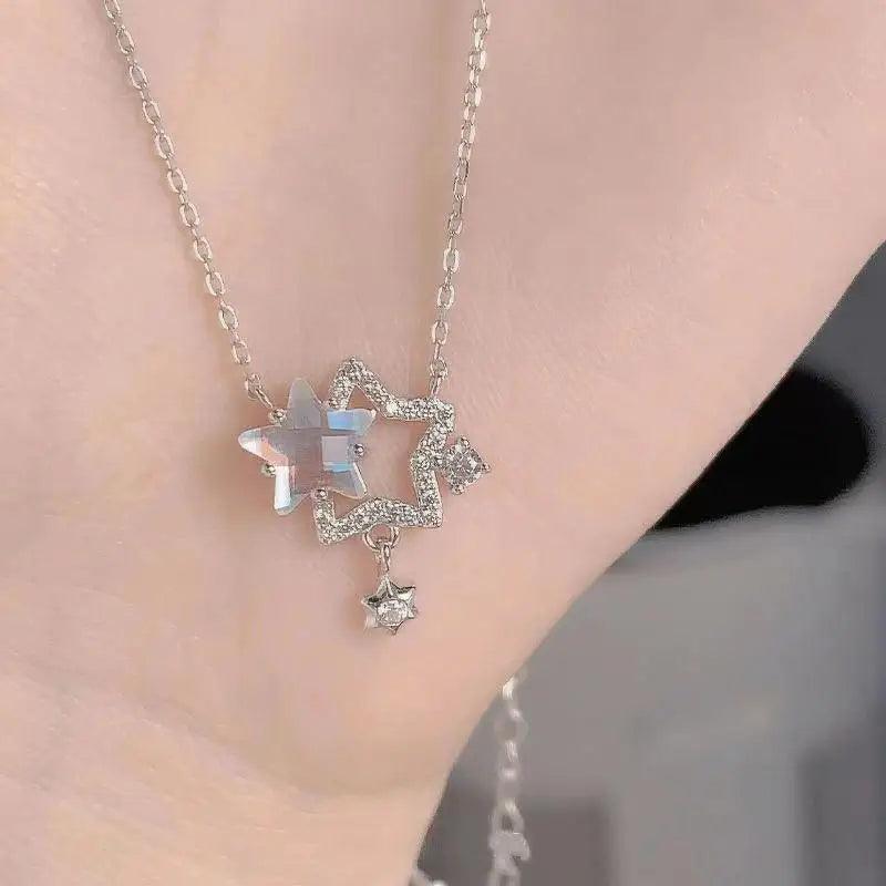 Star pendant necklace with silver-tone chain, iridescent rhinestones, and dangling star charm