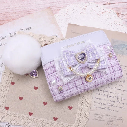 Lavender quilted wallet with bow and heart charms, pearl trim, and gold-tone zipper