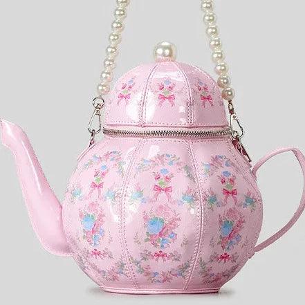 Pink teapot-shaped mini bag with pearl beaded strap and bow-and-flower print