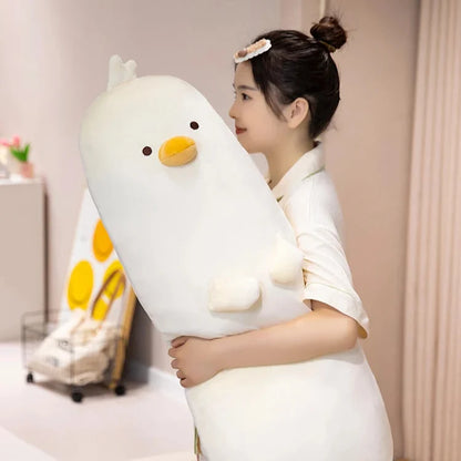 Long white chick plush pillow, upright with embroidered face and wing details