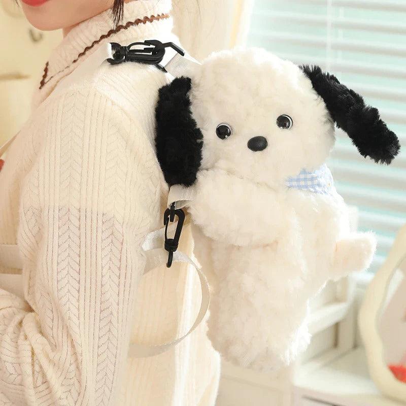 Plush crossbody bag with white puppy plush, black ears, blue bandana, clip strap