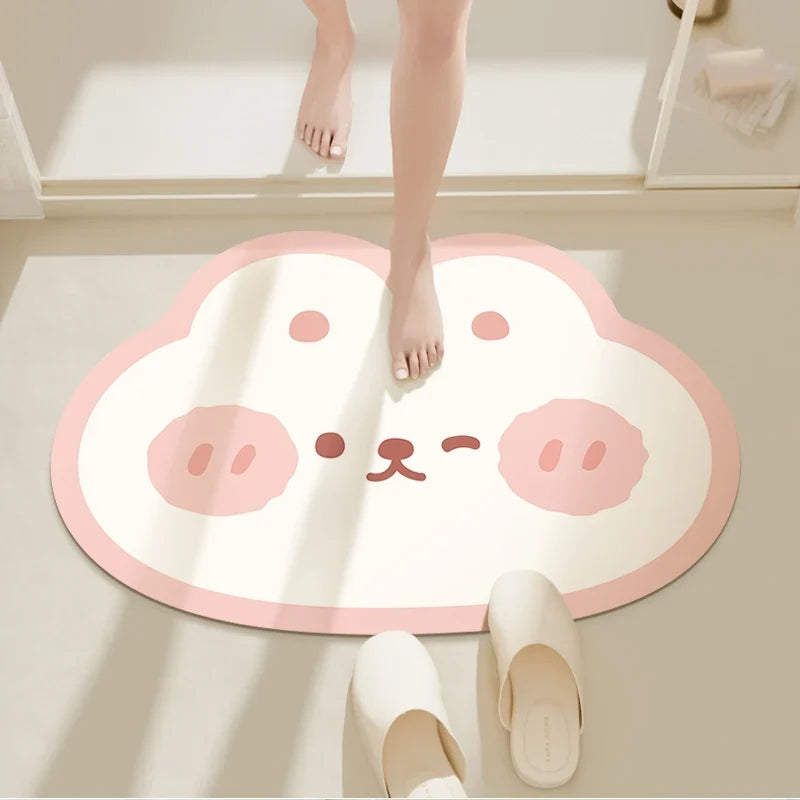 Round bathroom floor mat with cute bunny face in pink and cream tones