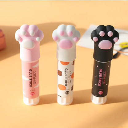 Cat paw glue stick set of three: white, light pink, and black tubes with paw caps