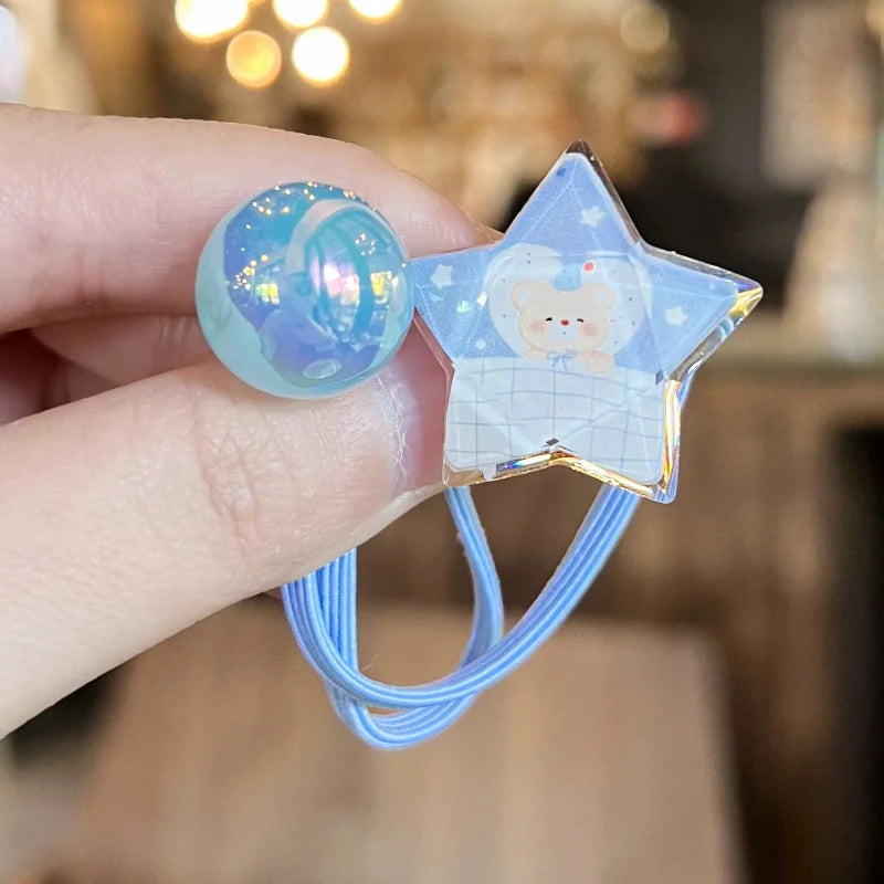 Light blue elastic hair tie with star charm and iridescent round bead on elastic cord