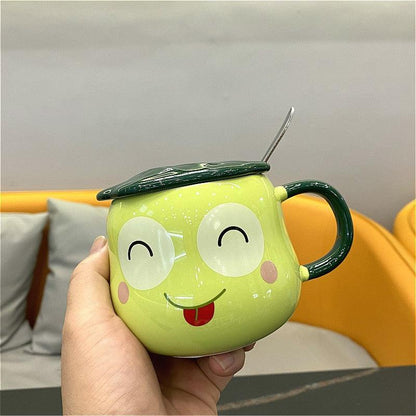 Lime green frog-shaped mug with lid and spoon, front view with eyes and open smile design