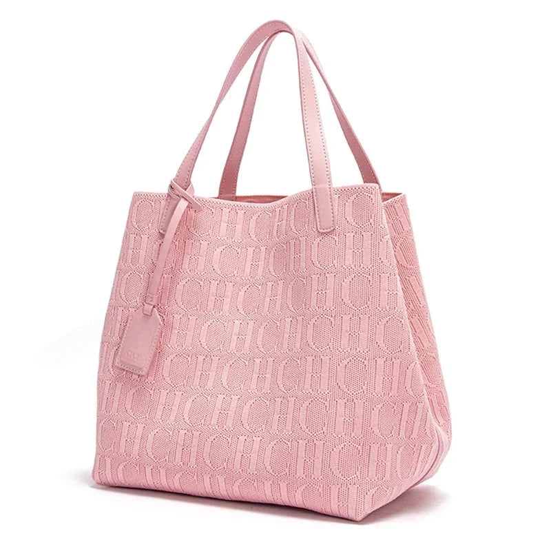 Pink knitted tote bag with embossed CHCH pattern, dual top handles, hanging tag.