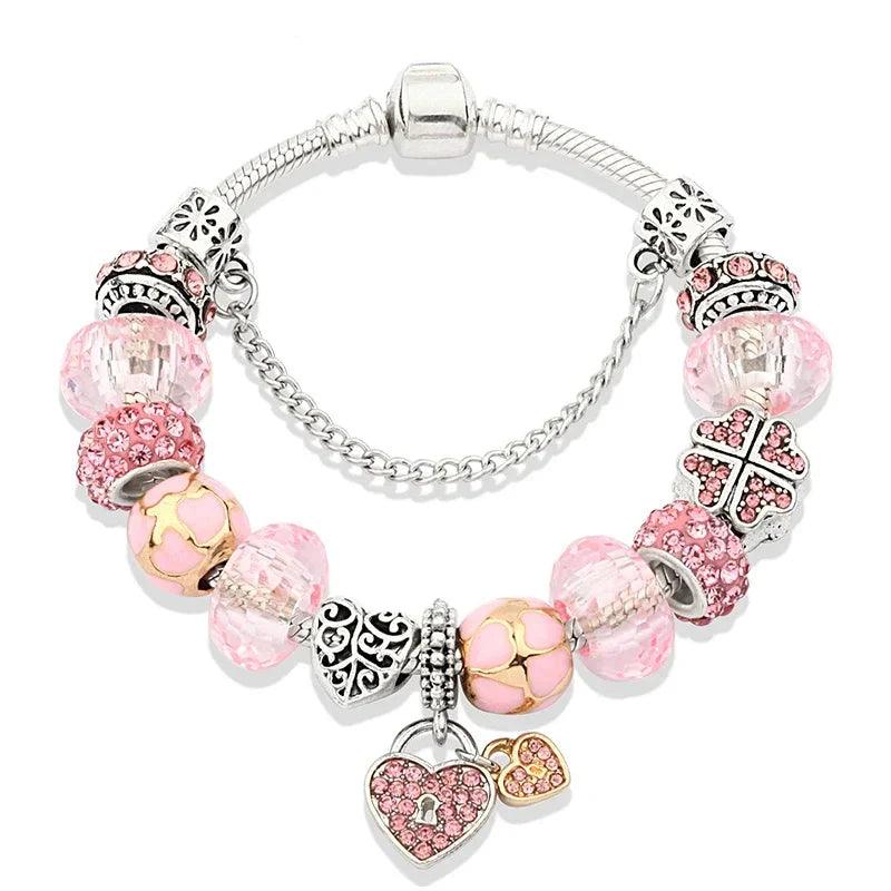 Pink charm bracelet with silver beads, elephant, cross, and heart charms