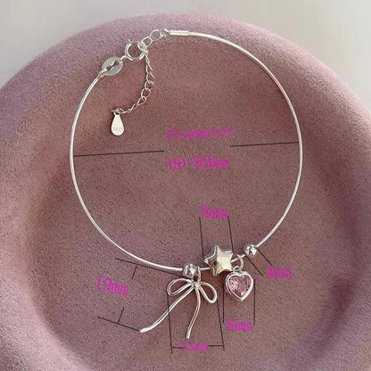 Silver heart and bow charm bracelet with star centerpiece and pink heart accents