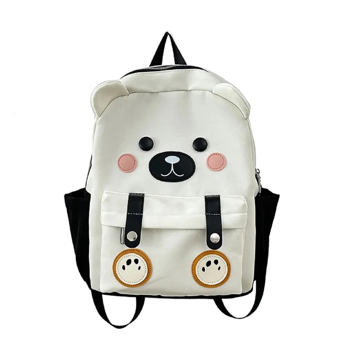 White cute bear backpack with bear-face patch, black straps, and front pockets