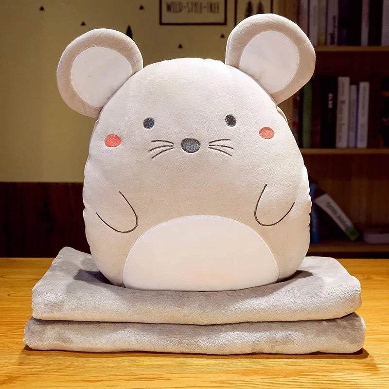 Mouse animal cushion blanket with plush face on folded light-gray blanket layers