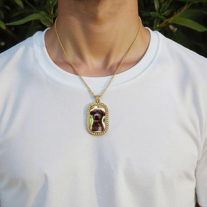 Gold photo pendant necklace on a person’s neckline with diamond-studded oval charm