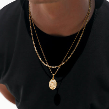 Gold oval pendant on layered chain necklace