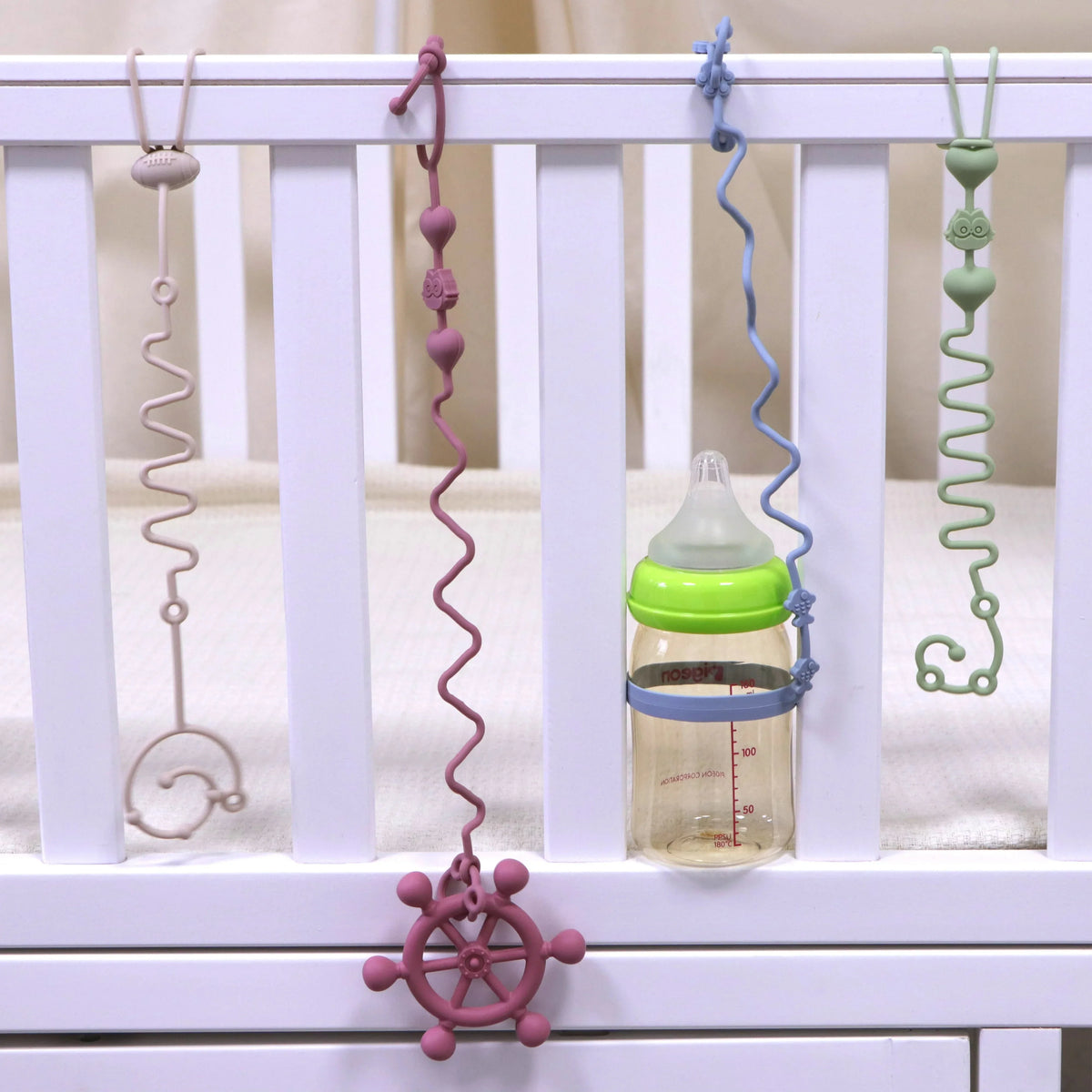 Baby crib hanging pacifier and teether chains with clips and a bottle attachment
