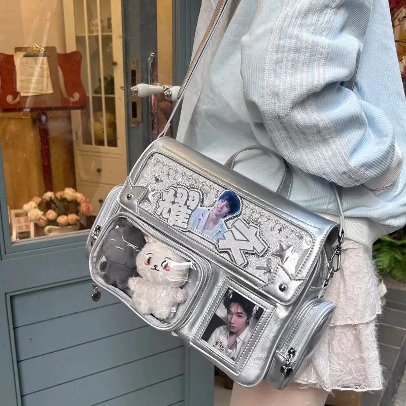 Silver ita shoulder bag with star applique, clear pockets, and crossbody strap