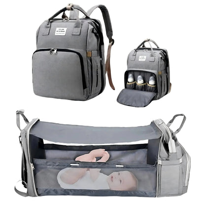 Gray diaper bag backpack with foldable baby bed and transparent viewing window.