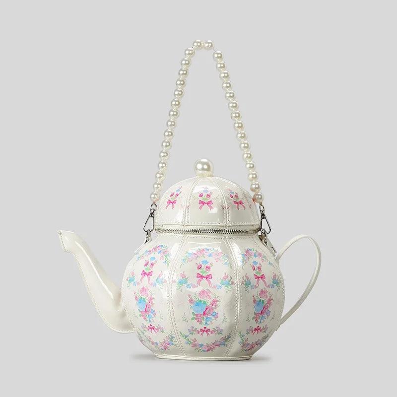 White teapot-shaped mini bag with pearl beaded handle and colorful floral print