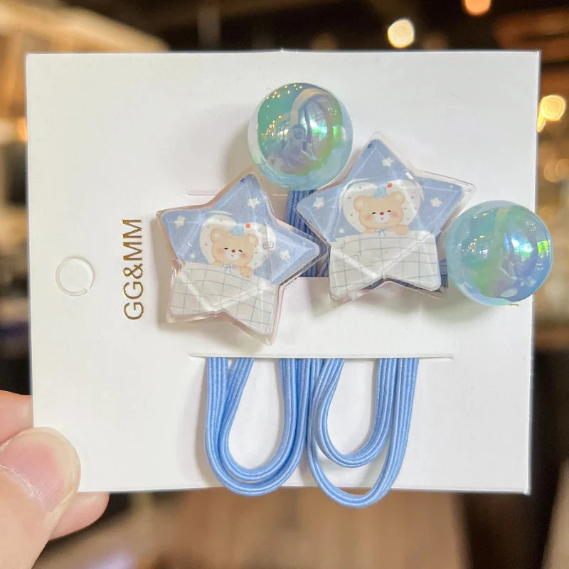 Blue elastic hair ties with star and bear charms, plus iridescent round charm beads