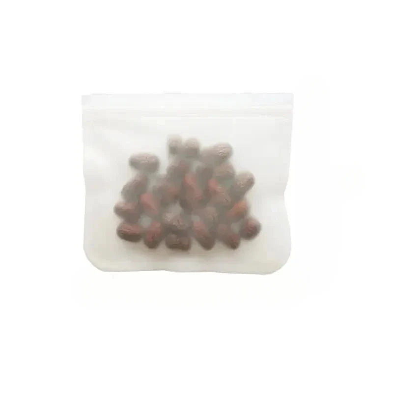 Reusable silicone food storage bag with clear zip top, filled with dark chocolate pieces