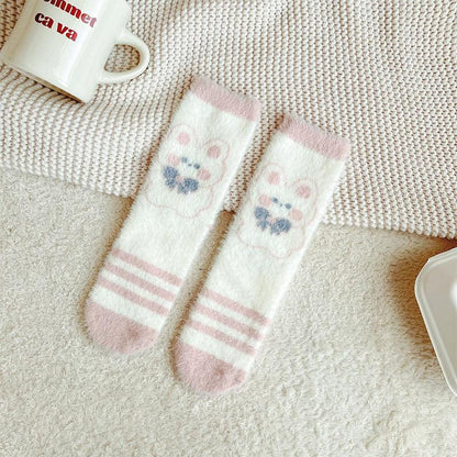 Bunny socks in white with blue paw prints and pink stripes at the toe area.