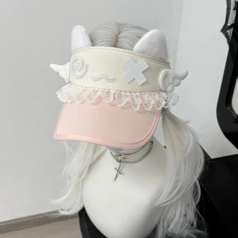 Pink cat-ear visor with lace trim and white confused kitty face patch