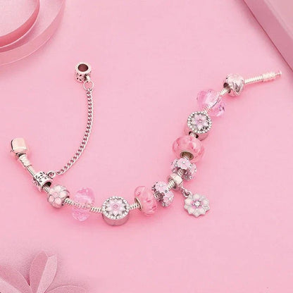 Pink charm bracelet with silver chain, round pink beads and flower charms, clasp