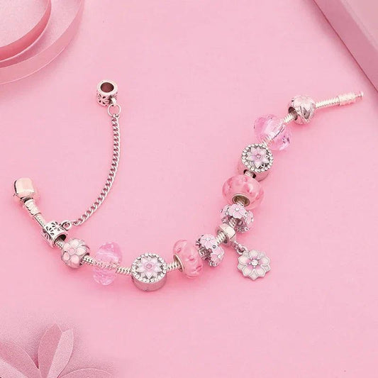 Pink charm bracelet with silver chain, round pink beads and flower charms, clasp