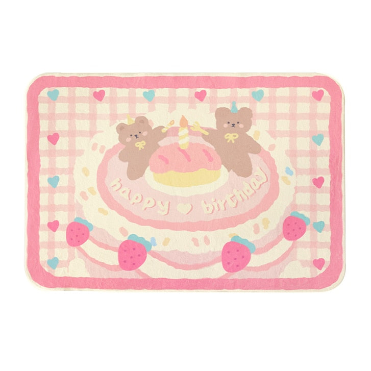 Pastel plush area rug with “Happy Birthday” design, cake and bear characters in pink and red