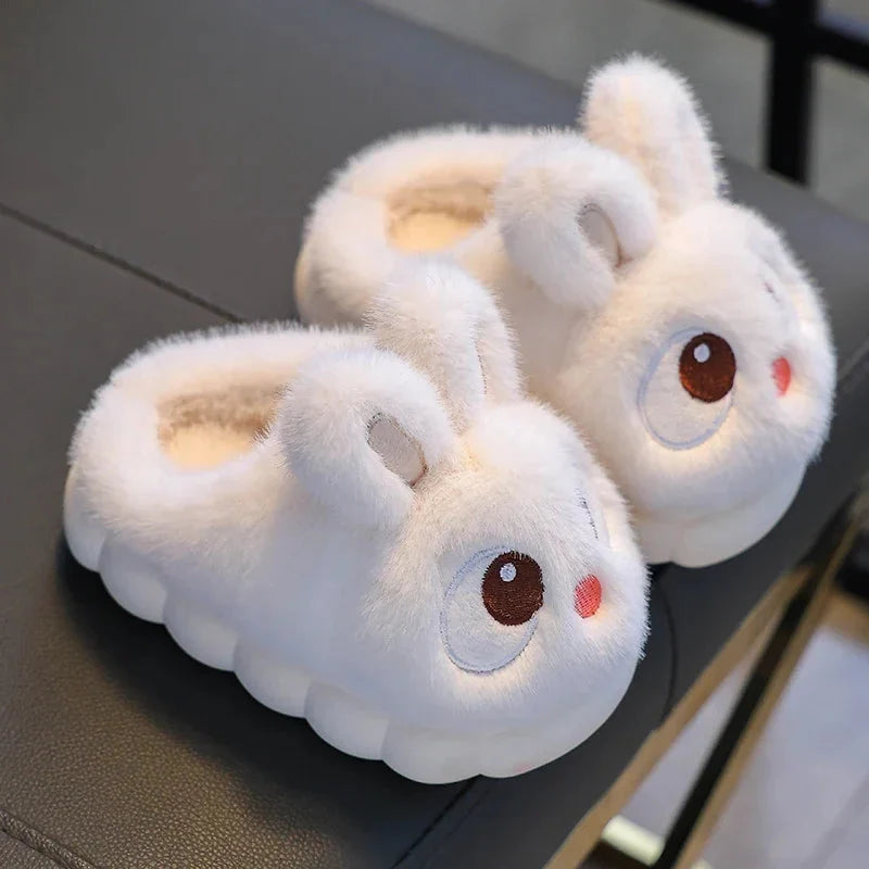 Kids rabbit plush winter slippers in fluffy white with light tan accents and big eyes