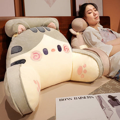 Grey cat reading pillow on seat, showing plush head hood, swirl face, and side paws
