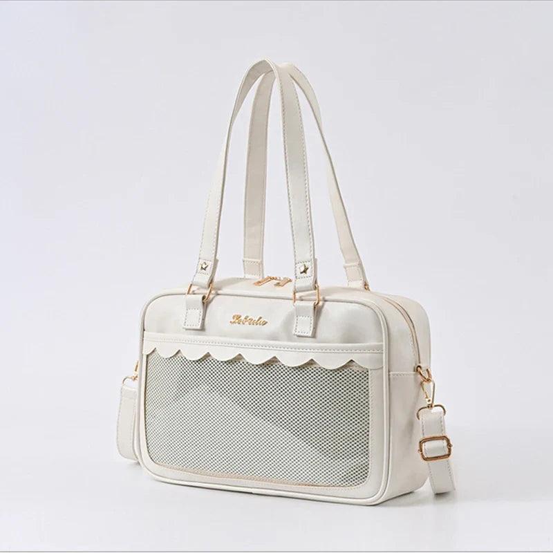 White Ita messenger bag with mesh-texture panel, scalloped top, double handles