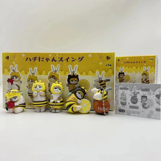 Bee and cat twisted egg anime figure keychains set in a yellow retail display box