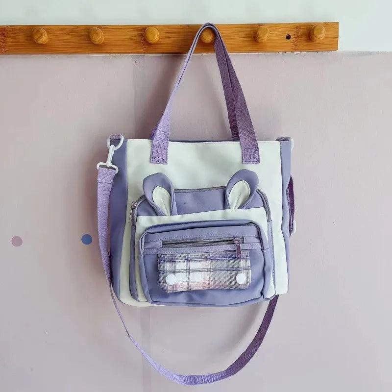 Purple bunny ears tote shoulder bag with front pocket and top handles, crossbody strap