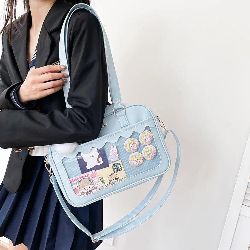 Light blue Ita messenger bag with character patchwork window and shoulder strap