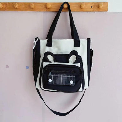 Black bunny-ear tote shoulder bag with front plaid pocket and dual top handles