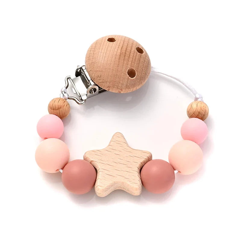 Baby pacifier clip with wooden star teether and silicone beads, pink and light wood