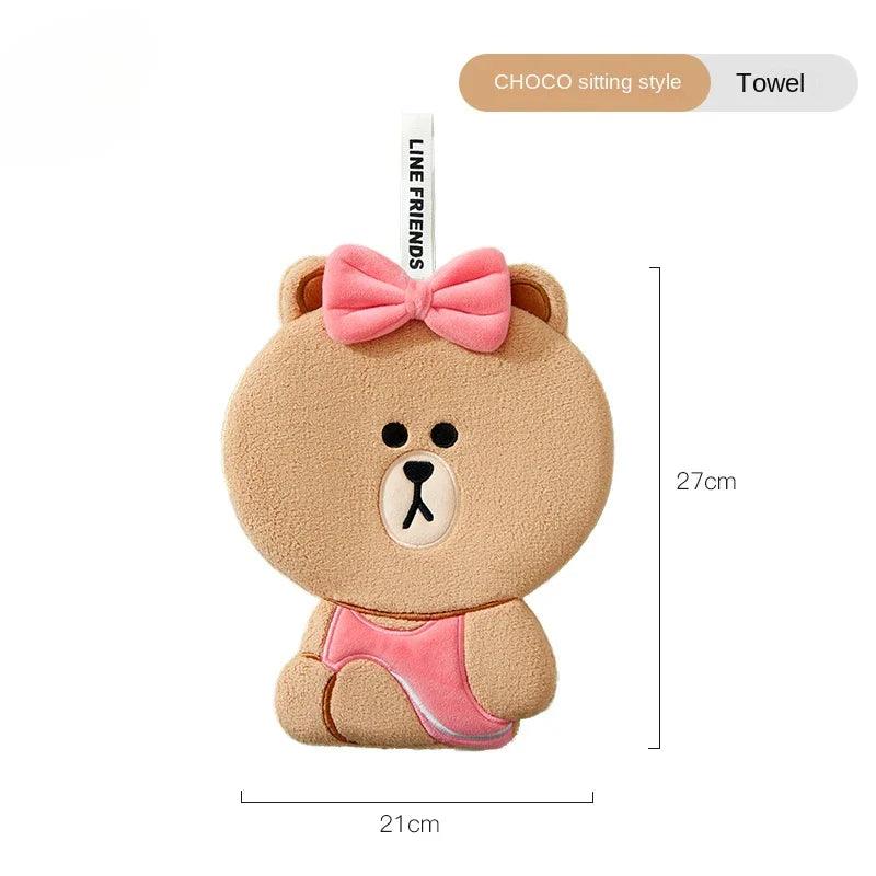 Light-brown sitting teddy bear hand towel with pink bow and stitched bear face