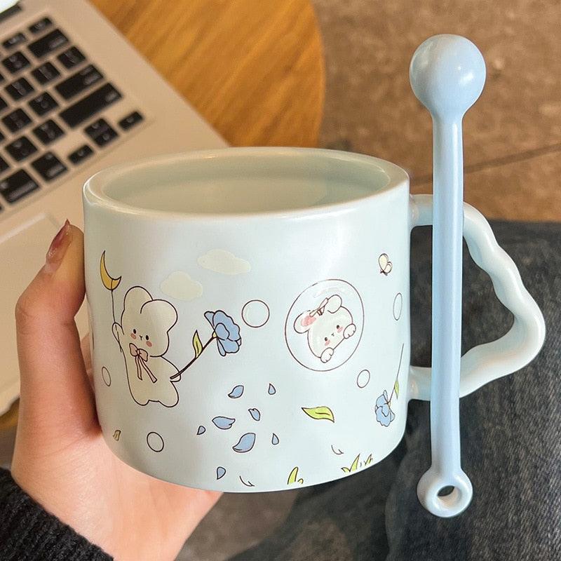 Light blue bunny flower mug with small flowers, cloud icon, and spoon-shaped handle