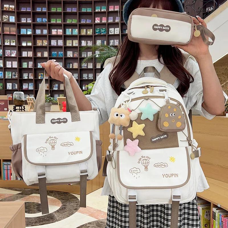 Beige/tan 3-piece backpack set with character artwork on front pockets and straps