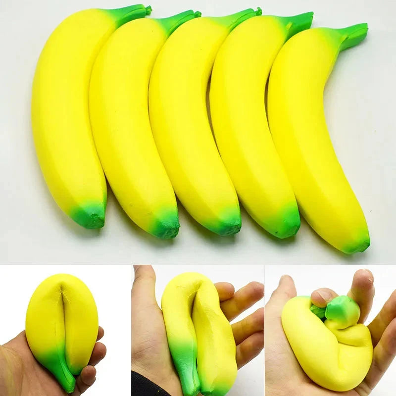 Jumbo squishy banana toy in yellow with green ends, shown in a small hand
