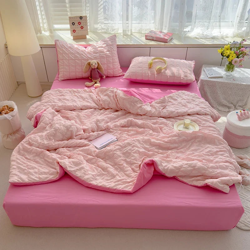 Pink seersucker summer duvet cover set with matching pillowcases and quilted texture
