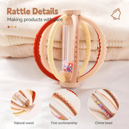 Baby rattle teether toy close-up with wooden body and chime bead center