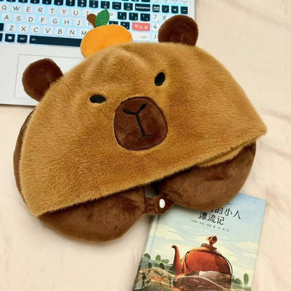 Capybara plush neck pillow hat in tan and brown with stitched face and ear details.