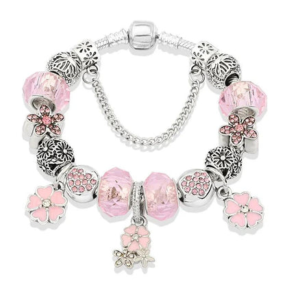 Pink charm bracelet with silver-tone beads, pink glass charms and flower dangles, clasp