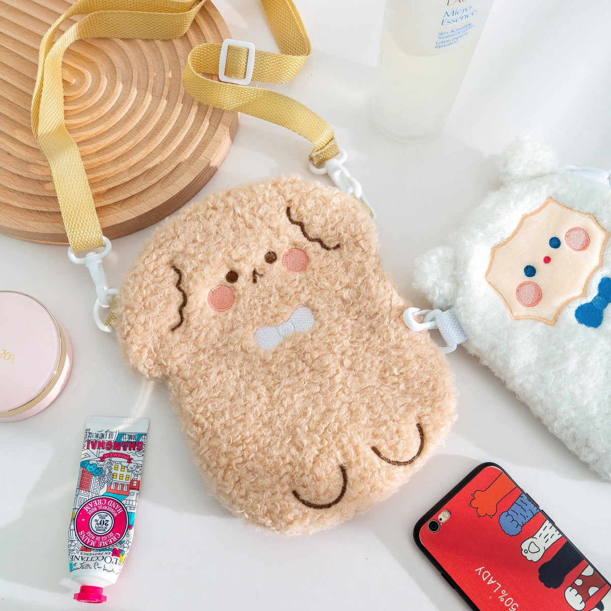 Tan plush bear crossbody bag with stitched face and adjustable shoulder strap