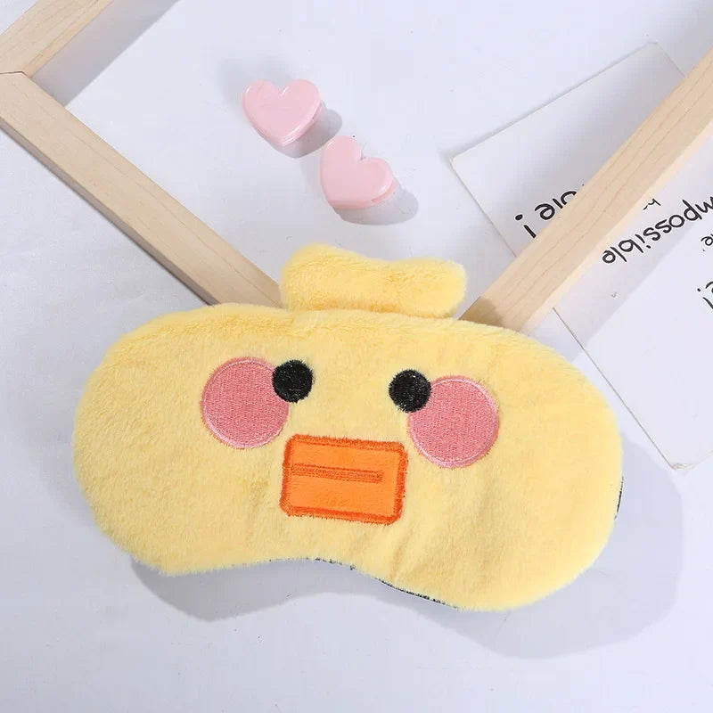 Duck plush sleep mask with yellow fabric, orange beak, and stitched round eyes with rosy cheeks