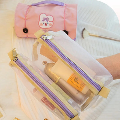 Pink roll-up makeup bag with bear patch beside two long clear zip pouches